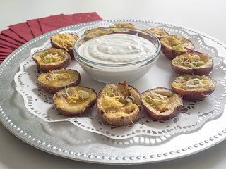 Stuffed potato skins with dipping sauce.
