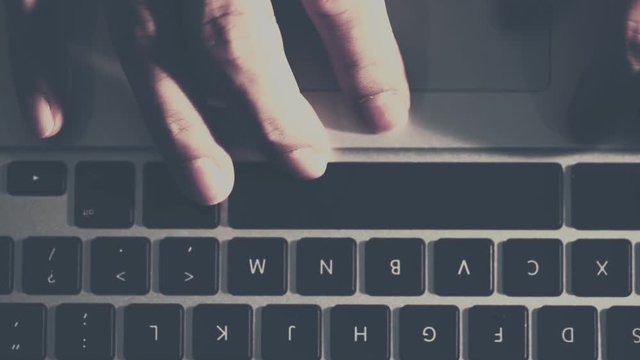 Top view of Close up macro shot.hand typing on keyboard laptop computer in 4K (UHD)