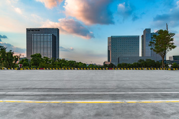 empty road and modern office buildings against blue sky