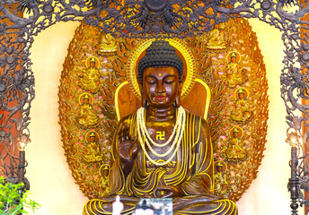 Ho Chi Minh City, Vietnam - May 10th, 2017: Buddhist statue in temple decorated lights, colorful flowers on Buddha's birthday. A peacefull place to calm mine mind and soul in Ho Chi Minh city, Vietnam