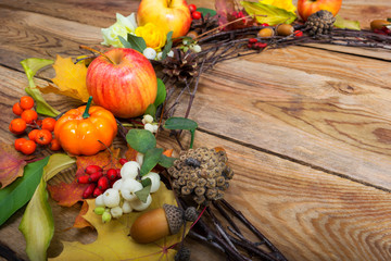 Thanksgiving wreath with pumpkins, apples, white berries, copy space