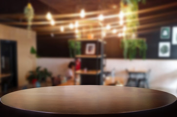 Selected focus empty brown wooden table and Coffee shop or restaurant blur background with bokeh image. for your photomontage or product display.