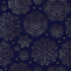 Floral seamless pattern with stylized snowflakes. Golden line snowflake on dark blue background.