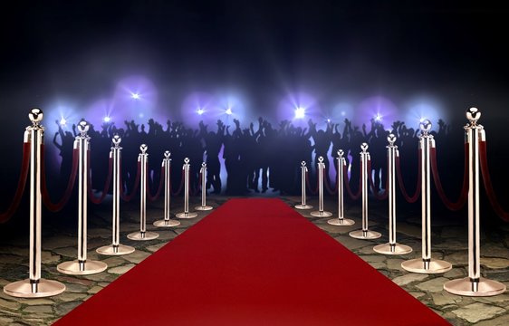 Red carpet between rope barriers and crowd