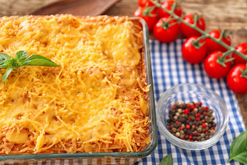 Composition of meat lasagna and tomatoes on table