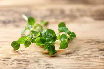 Fresh aromatic oregano on wooden background