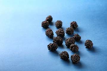 Delicious blackberries on color background