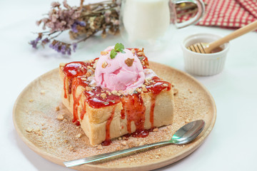 Toast topping with strawberry jam and ice cream.