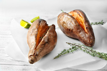 Baked sweet potato on white table