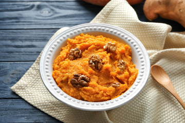 Plate with mashed sweet potato on table