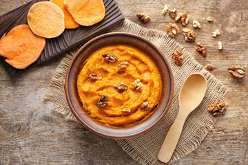 Bowl with mashed sweet potato on table