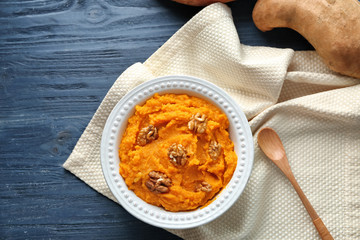 Plate with mashed sweet potato on table
