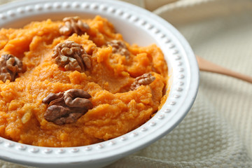 Plate with mashed sweet potato on table, closeup
