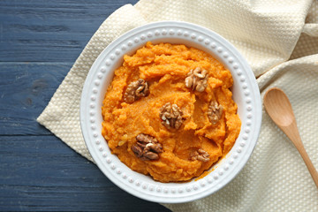 Plate with mashed sweet potato on table