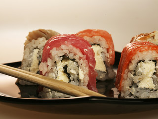 japanese  rolls on black plate.