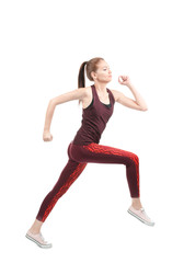 Young sporty woman running on white background