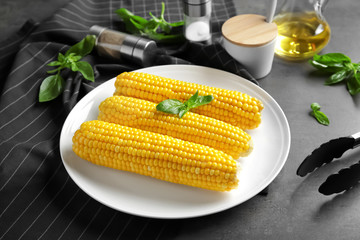 Tasty corn cobs on plate