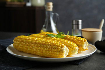 Tasty corn cobs on plate