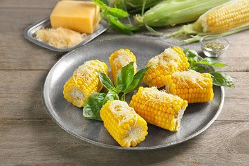 Tasty corn cobs on plate