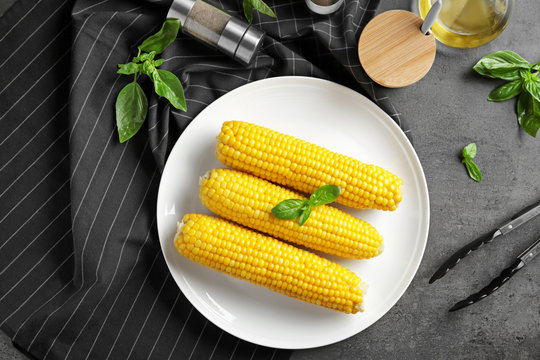 Tasty corn cobs on plate