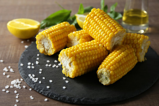 Tasty corn cobs on slate plate