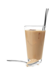Glass with protein shake and powder in spoon on white background