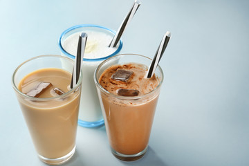 Glasses with different protein shakes on table