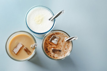 Glasses with different protein shakes on table