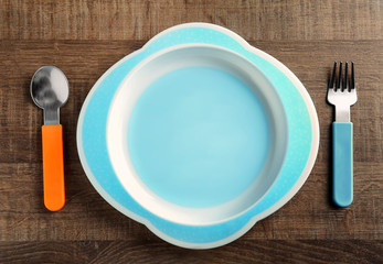 Bright baby dishware on table