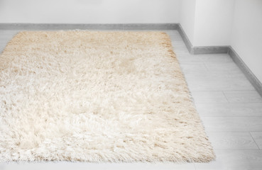 White soft carpet on wooden floor indoors