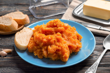 Plate with mashed sweet potato on table