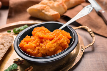 Bowl with mashed sweet potato on metal tray