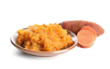 Plate with mashed sweet potato on white background