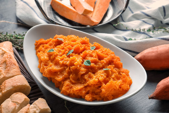 Bowl with mashed sweet potato on table