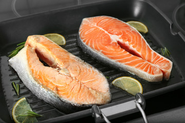 Delicious salmon steaks on grill pan, closeup