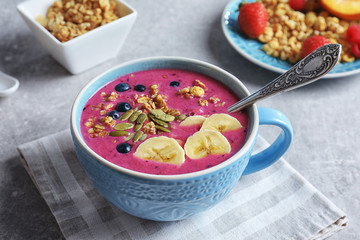 Cup with acai smoothie on table