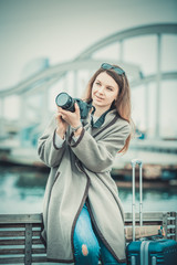 Cheerful girl taking picture with her camera