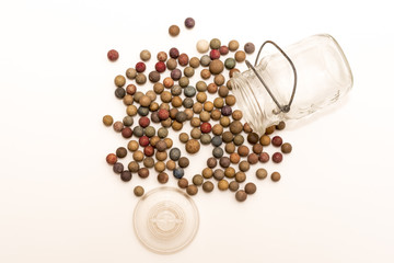 Spilled clay marbles empty glass jar
