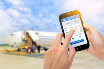 business concept: man using a digital generated phone with tickets flights web and airport background