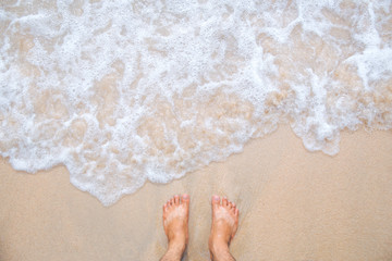 Sea wave movement with feet and sand.