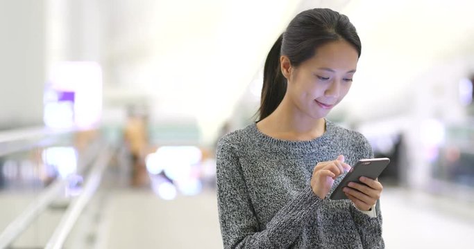 Woman use of mobile phone in airport