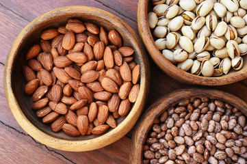 almond and pinto bean with pistachios in wooden bowl 
