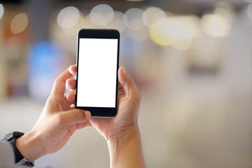 Mockup smartphone blank screen in man hands over blurred background.