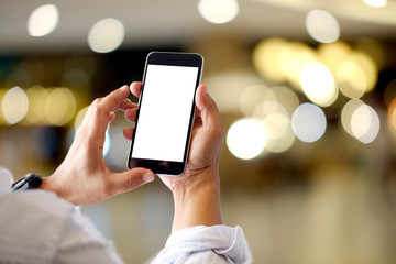 Mockup smartphone blank screen in man hands over blurred background.