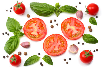 mix of slice of tomato, basil leaf, garlic and spices isolated on white background. top view