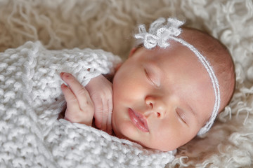Amazing newborn baby sleeping beauty enjoying first days in her his life in luxury tender clothes and blankets made by couturier