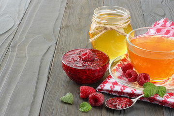 healthy background. raspberry with raspberry jam and honey on dark wooden table