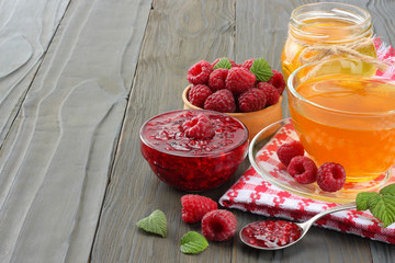 healthy background. raspberry with raspberry jam and honey on dark wooden table