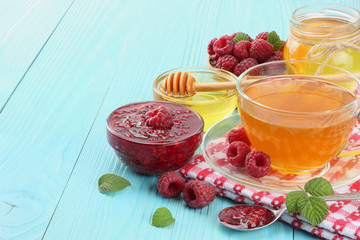 healthy background. raspberry with raspberry jam and honey on blue wooden table