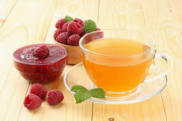 healthy background. raspberry with raspberry jam and tea on light wooden table
